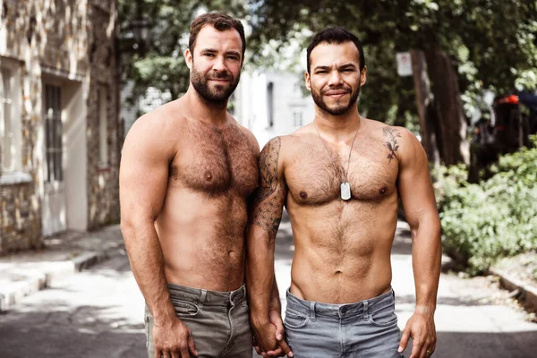 Un retrato de una feliz pareja gay al aire libre en el fondo urbano Imágenes de stock libres de derechos