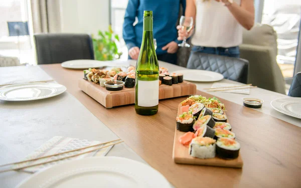 Table dinner with traditional sushi dishes and drinks — Stockfoto