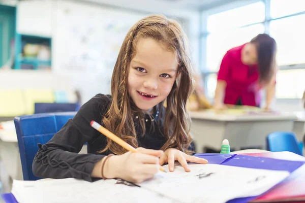 Education and school concept little student girl studying at school — Photo