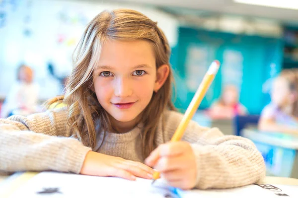 Education and school concept little student girl studying at school — Foto de Stock