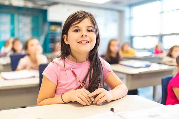 Education and school concept little student girl studying at school — Photo