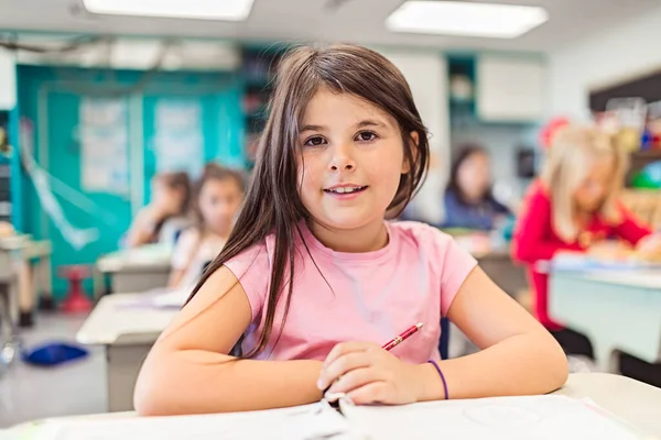 Education and school concept little student girl studying at school — Photo