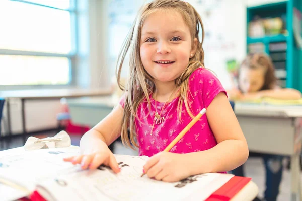 Education and school concept little student girl studying at school — Foto de Stock