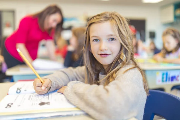 Education and school concept little student girl studying at school — Foto de Stock