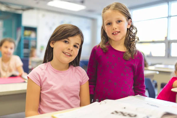 Education and school concept little student girl together studying at school — Photo