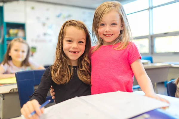 Education and school concept little student girl together studying at school — Stockfoto