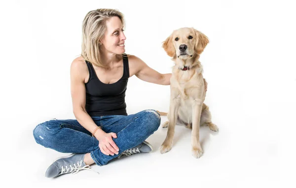 Nice woman and her beautiful Golden Retriever dog over white background — стоковое фото