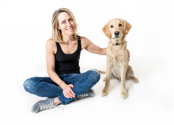 Nice woman and her beautiful Golden Retriever dog over white background — Stockfoto