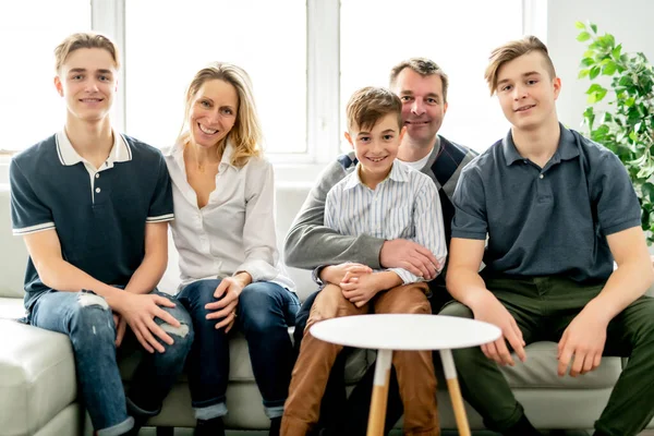 A Beautiful happy family sit on sofa at home — Stok fotoğraf