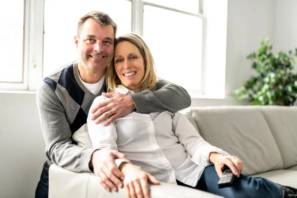 A Mature couple relaxing in couch at home — Photo