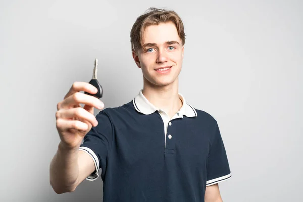 A teenager holding the key of his first car — 스톡 사진