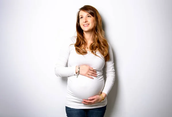 A Portrait of adorable pregnant woman in white — Stock fotografie