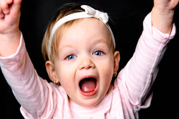 A cute little girl two years old over dark background — Stock Fotó