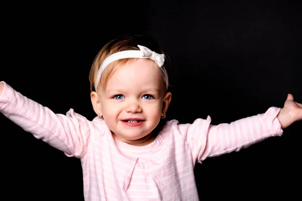 A cute little girl two years old over dark background — Stock fotografie