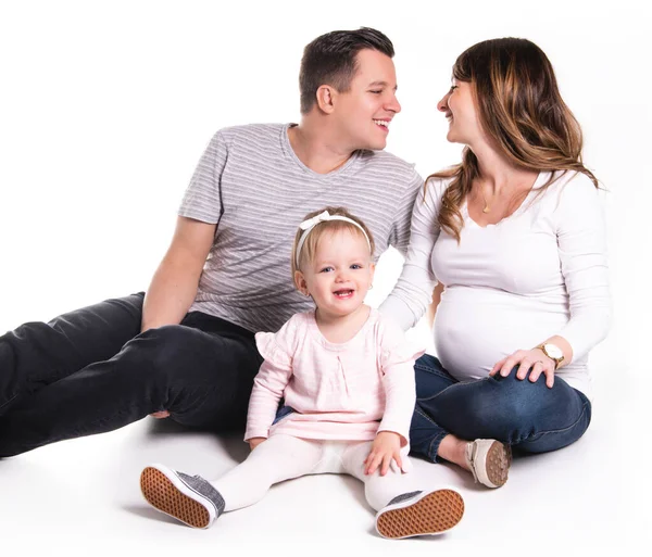 A beautiful happy family with a pregnant mother over white background — Stok fotoğraf