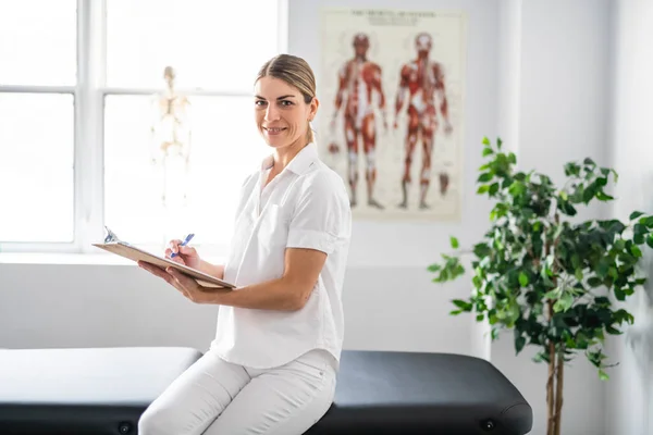 A Modern rehabilitation physiotherapy woman worker at job — ストック写真