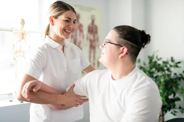 A Modern rehabilitation physiotherapy woman worker with client — Stok fotoğraf