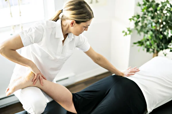 A Modern rehabilitation physiotherapy woman worker with client — Foto Stock