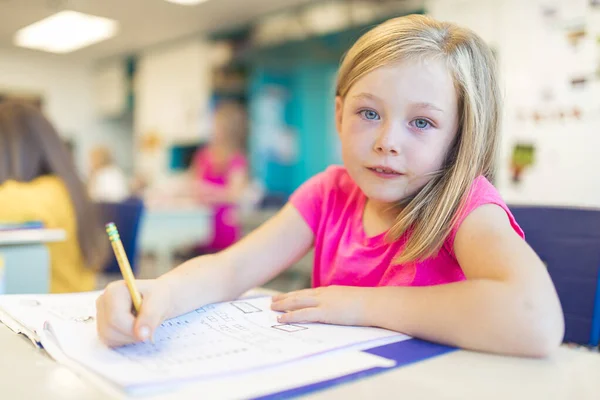 Education and school concept little student girl studying at school Stock Image