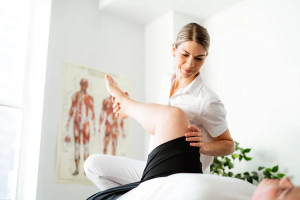 A Modern rehabilitation physiotherapy woman worker with client — Foto de Stock