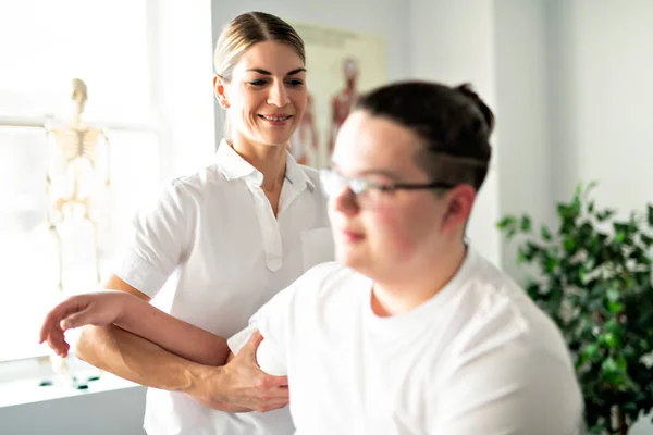 A Modern rehabilitation physiotherapy woman worker with client — Stok fotoğraf