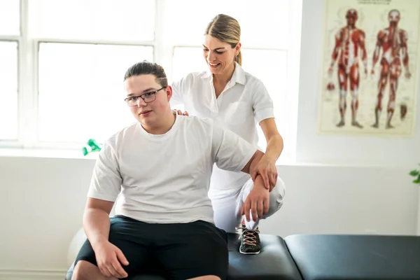 A Modern rehabilitation physiotherapy woman worker with client — Foto de Stock