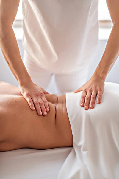 A Woman enjoying spa treatment at salon with masseur worker — Stock Photo, Image