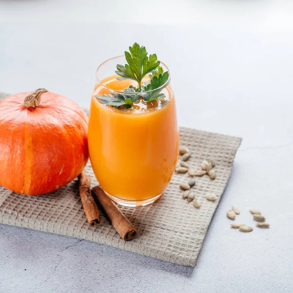 Healthy autumn drinks, pumpkin juice with parsley and pumpkin seeds, copy space