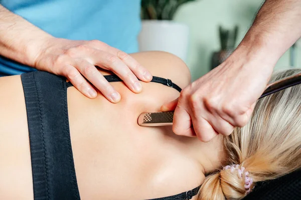 Chiropractor performing myofascial release techniques with IASTM tool for the Rhomboids — Stock Photo, Image