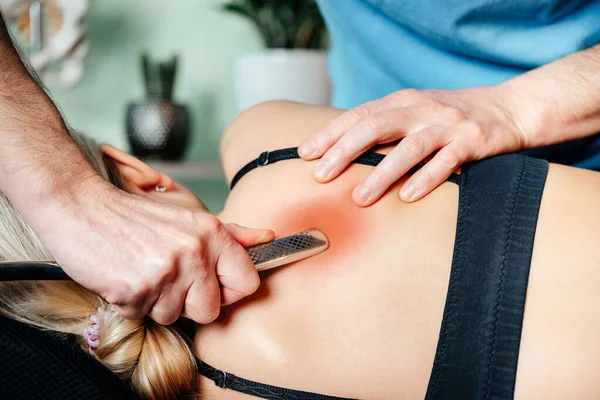 Chiropractor performing myofascial release techniques with IASTM tool for the Rhomboids — Stock Photo, Image