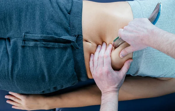 Chiropractic diaphragm myofascial release with IASTM tool, osteopath releasing tension in diaphragm muscles — Stock Photo, Image