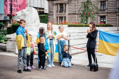 Glasgow, Scotalnd - July 30, 2022 children performing at Anti-Russia protest with participants calling for Russia to be recognised as a terrorist state, war in Ukraine