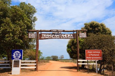 Pantanal entrance gate along Transpantaneira dirt road. Brazilian landmark. Road in perpective clipart