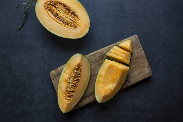 Fresh Juicy honeydew melon sliced on dark gray background .healthy food.hami melon.