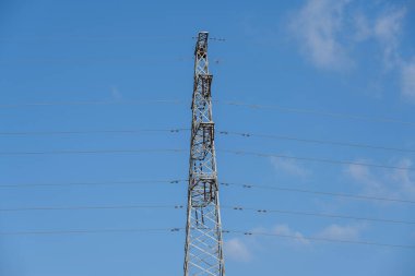 High-tension wires under a blue sky