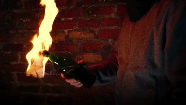Anonymous Man Throws Molotov Cocktails Brick Wall — Stock Video