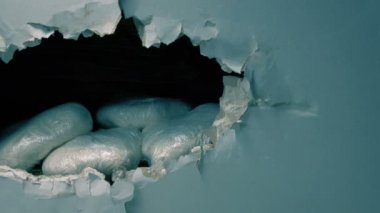 Passing Wall With Stashed Drug Bags Revelead