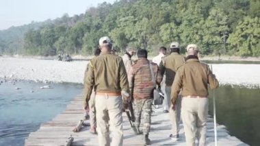  Forest officials patrol in Ram Ganga river close to Jim Corbett national park in India to protect animals from poachers. HQ Apple Prores 60 FPS 4k footage.
