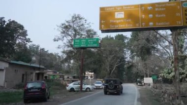 Sign board on the road for the tourist and transportation in the Dense forest of Jim Corbett national park. High-quality Apple Prores 4k footage.