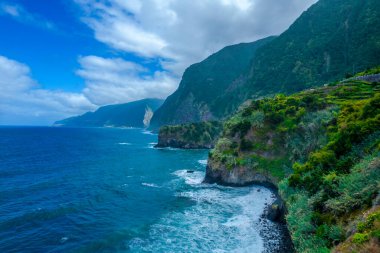 Aerial view of green rocks and mountains shore in Madeira island