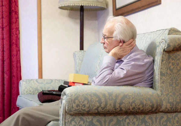 Senior elderly man relaxing watching tv indoors at home