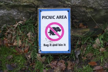 Köpek pisliği torbaya koy ve piknik alanında imzala.