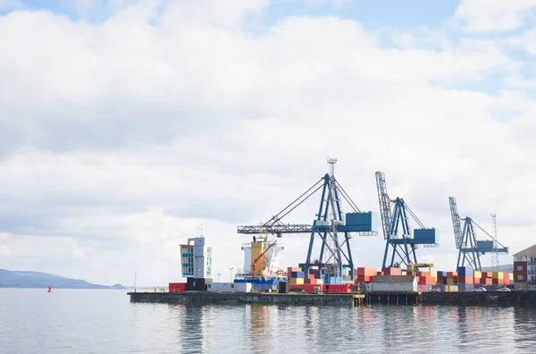 Cranes at logistics port terminal for offloading containers UK