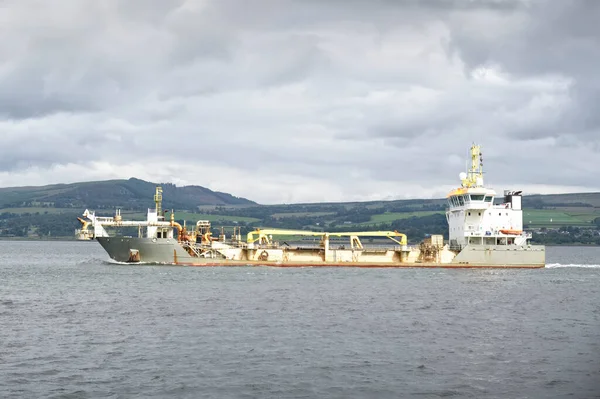 Ship transporting floating storage container platform in sea UK