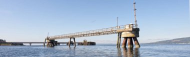 Old derelict wooden jetty pier in sea at Inverkip power station UK