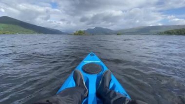 Blue kayak and wetsuit shoes on Loch Lomond UK