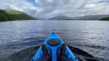 Blue kayak and wetsuit shoes on Loch Lomond UK