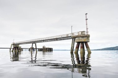 Old derelict wooden jetty pier in sea at Inverkip power station UK