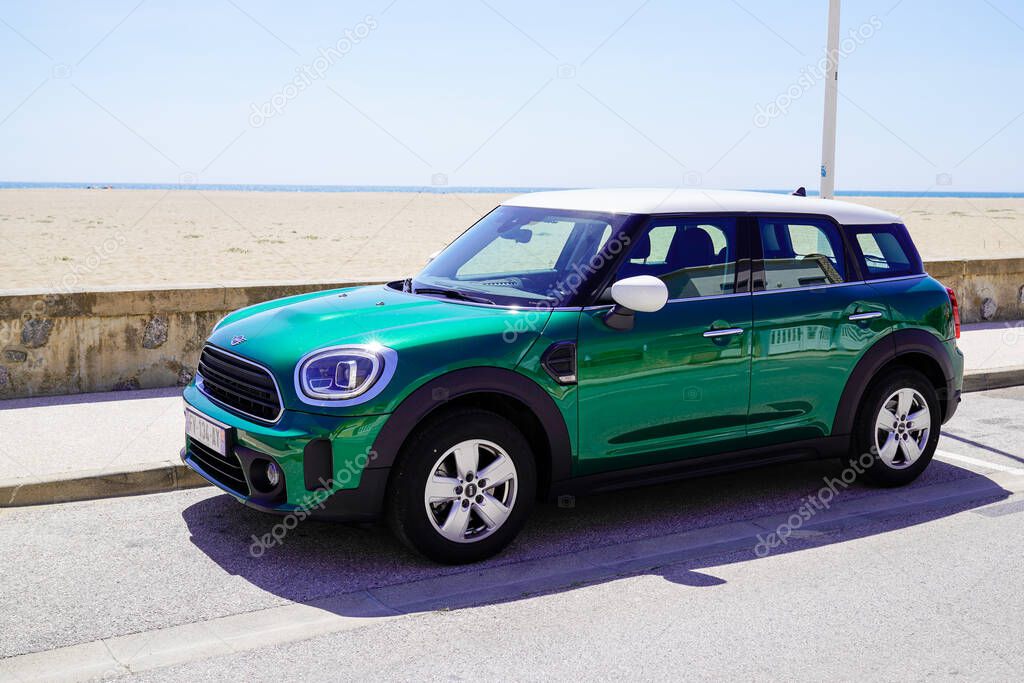 Bordeaux , Aquitaine  France - 09 30 2021 : MINI countryman car in racing green color side view in sea beach coast