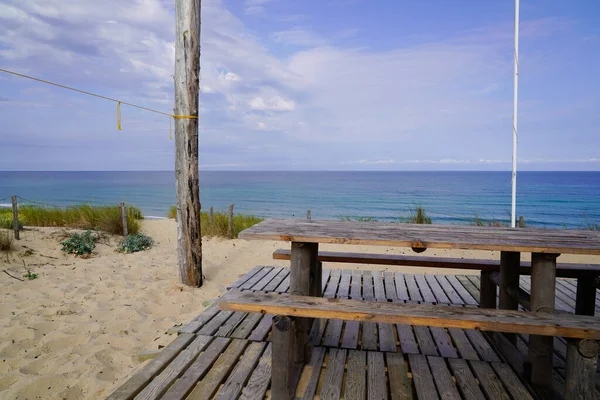 bench wooden pic nic table sandy beach view in summer day on Cap Ferret coast France